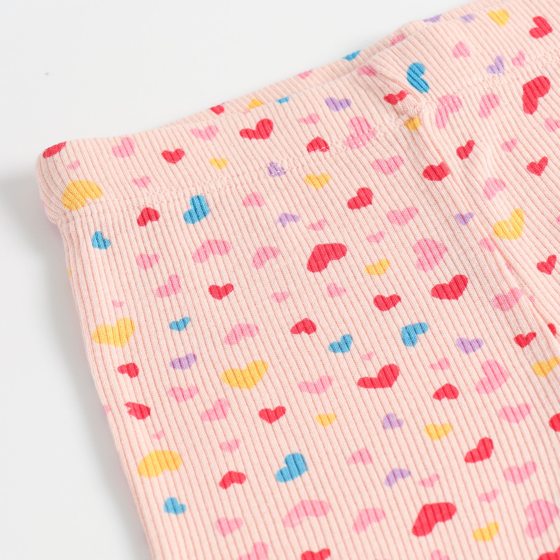 "Girls Pink Ribbed Cotton Leggings with All-Over Multicolor Heart Print"