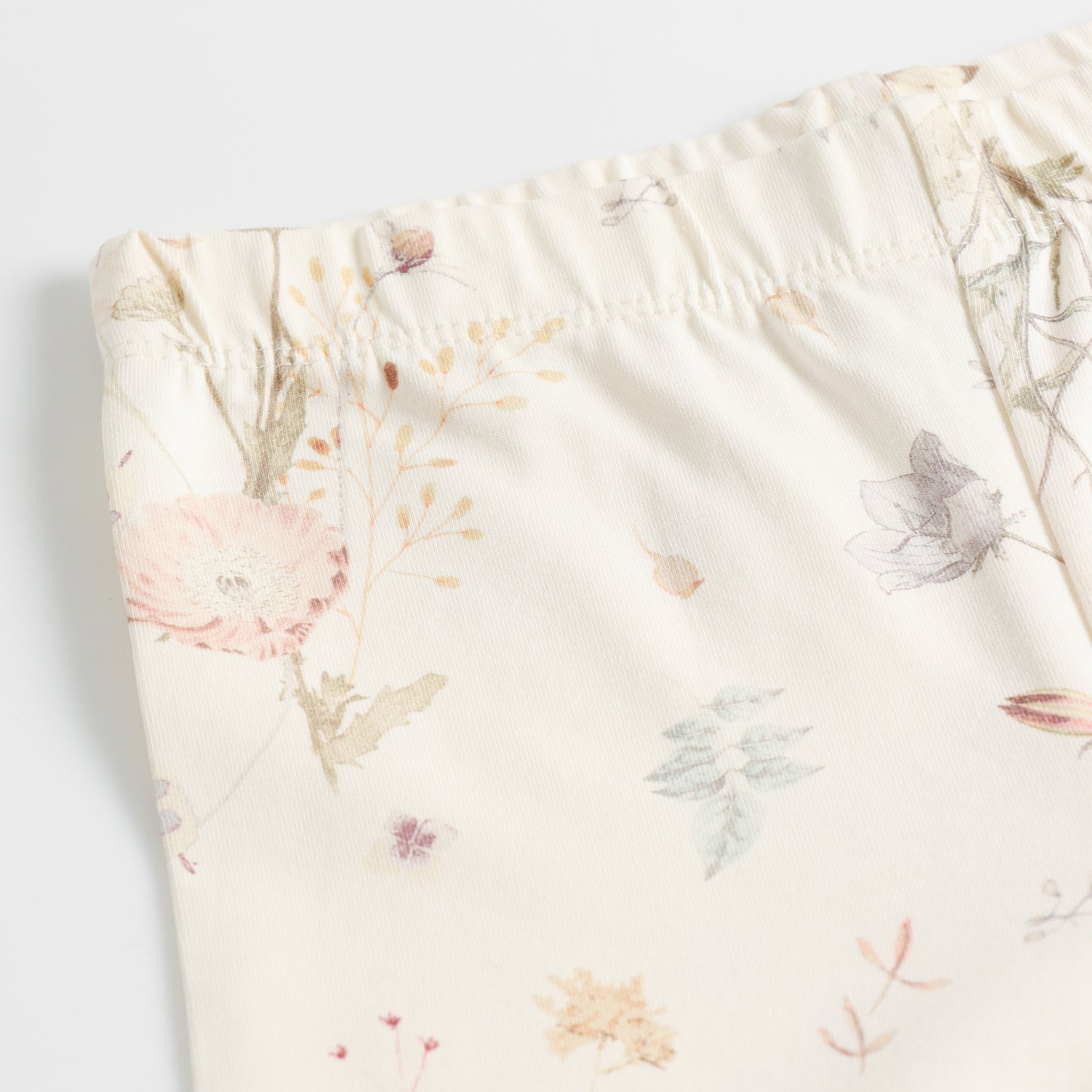 "Girls Cream Stretch Leggings with Delicate Pastel Botanical Floral Design"