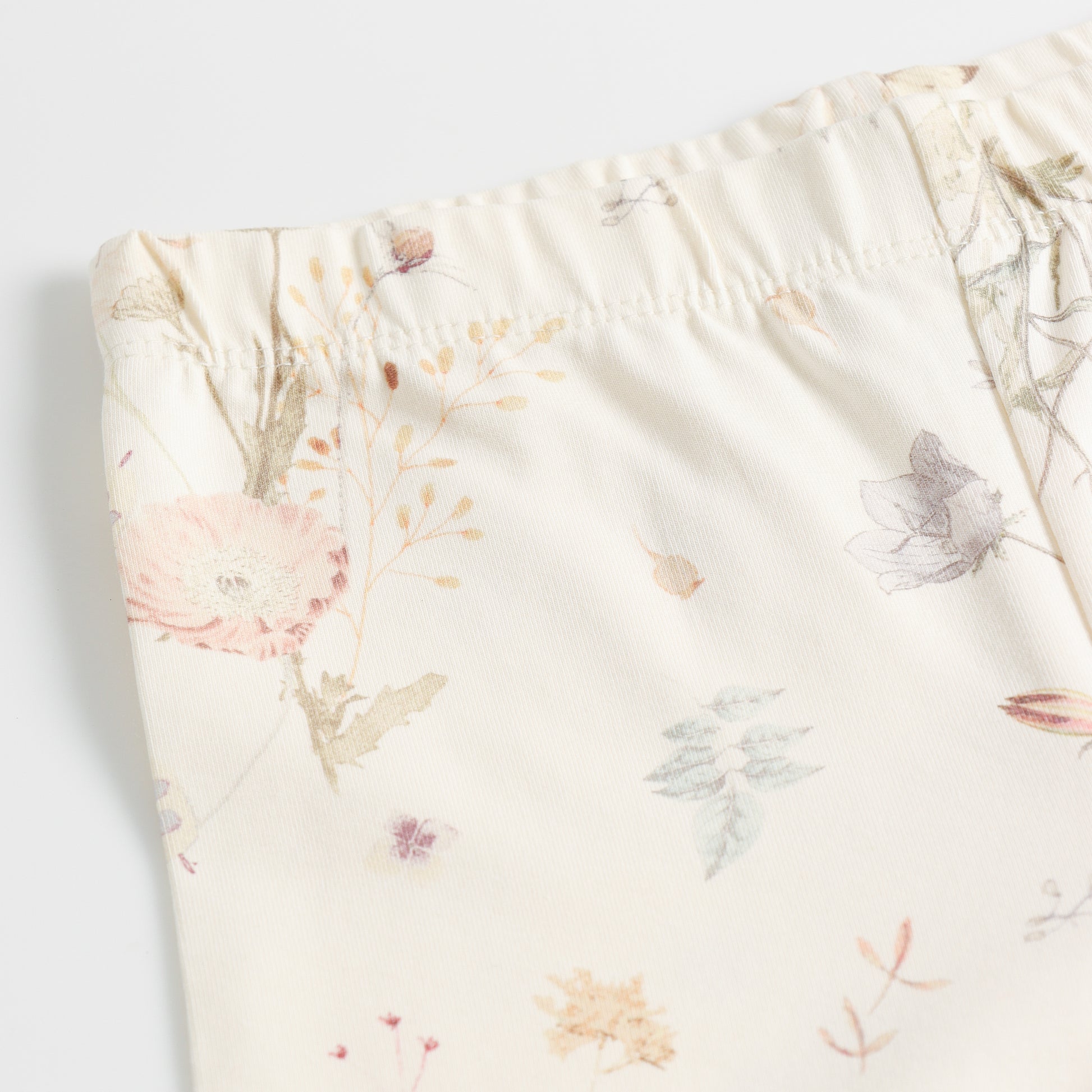 "Girls Cream Stretch Leggings with Delicate Pastel Botanical Floral Design"