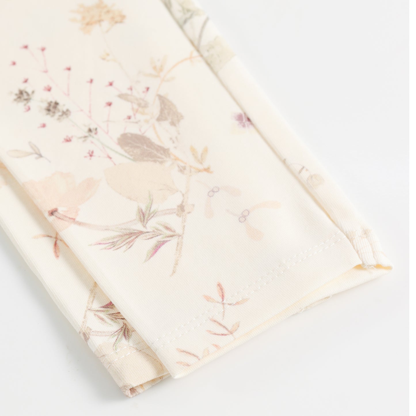 "Girls Cream Stretch Leggings with Delicate Pastel Botanical Floral Design"