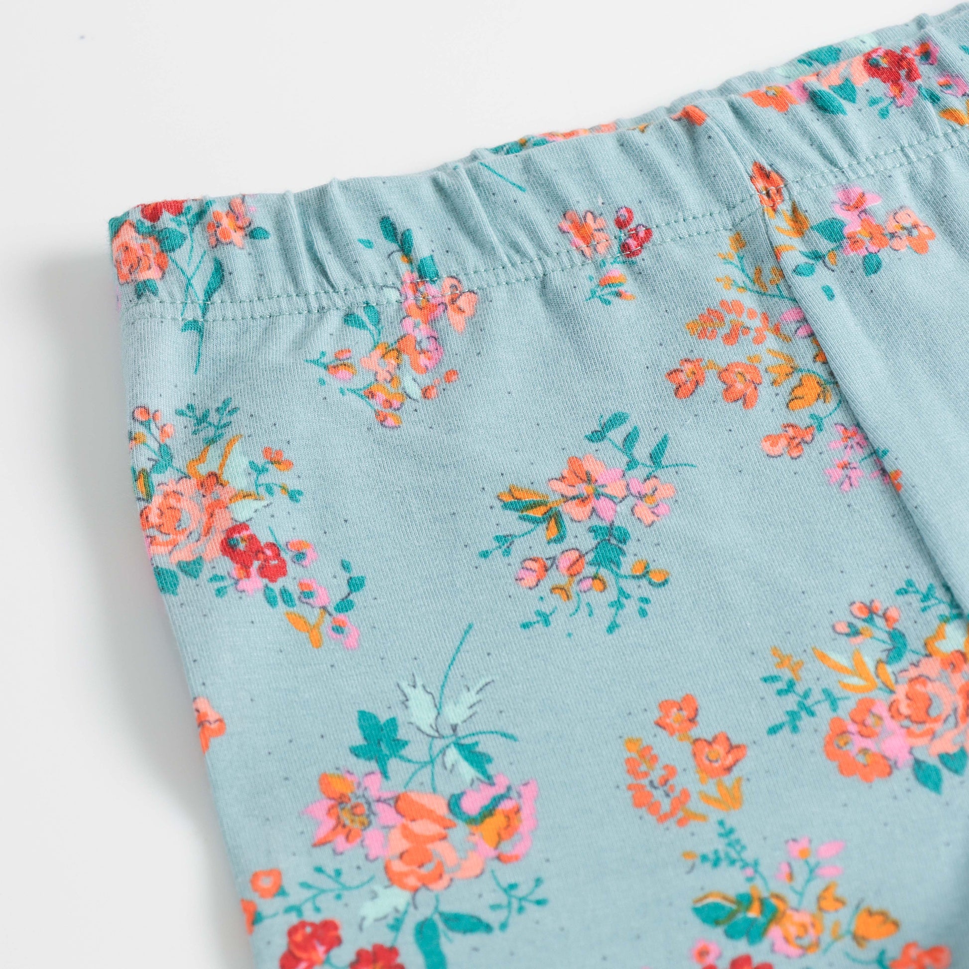 "Girls Turquoise Cotton Stretch Leggings with Bold All-Over Floral Design"