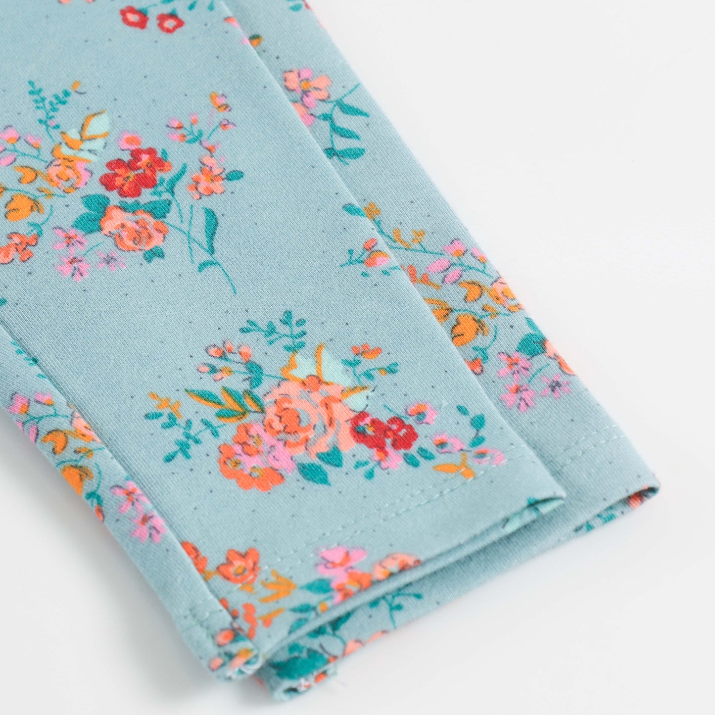 "Girls Turquoise Cotton Stretch Leggings with Bold All-Over Floral Design"